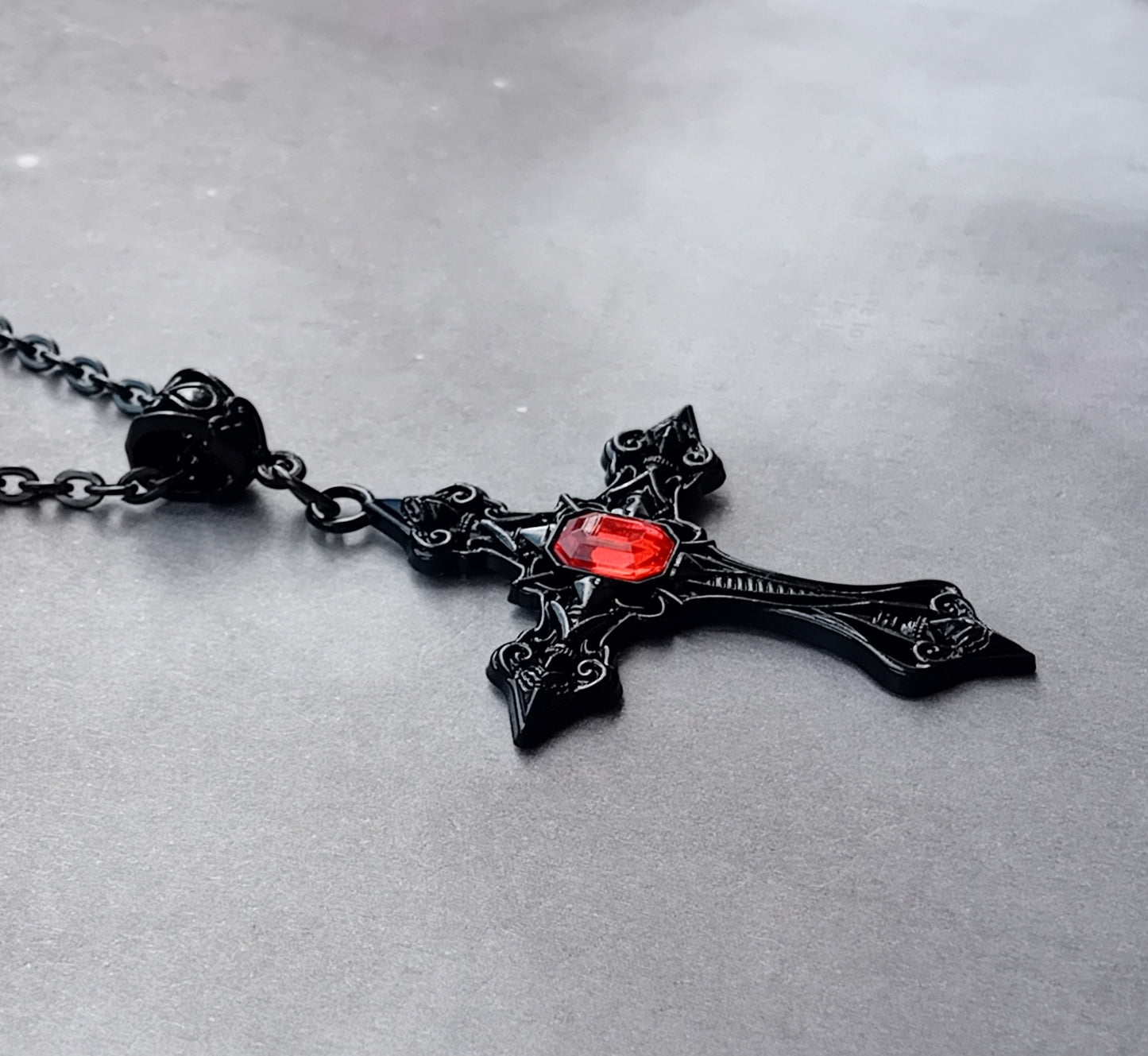 Black Patterned Cross with Red Stone