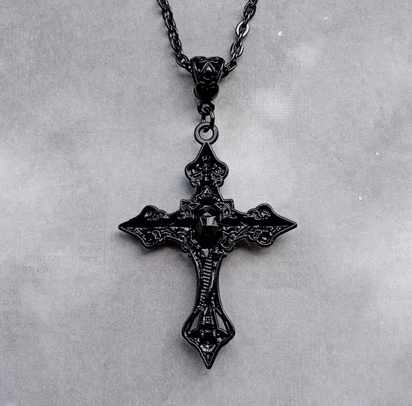 Black Patterned Cross with Red Stone