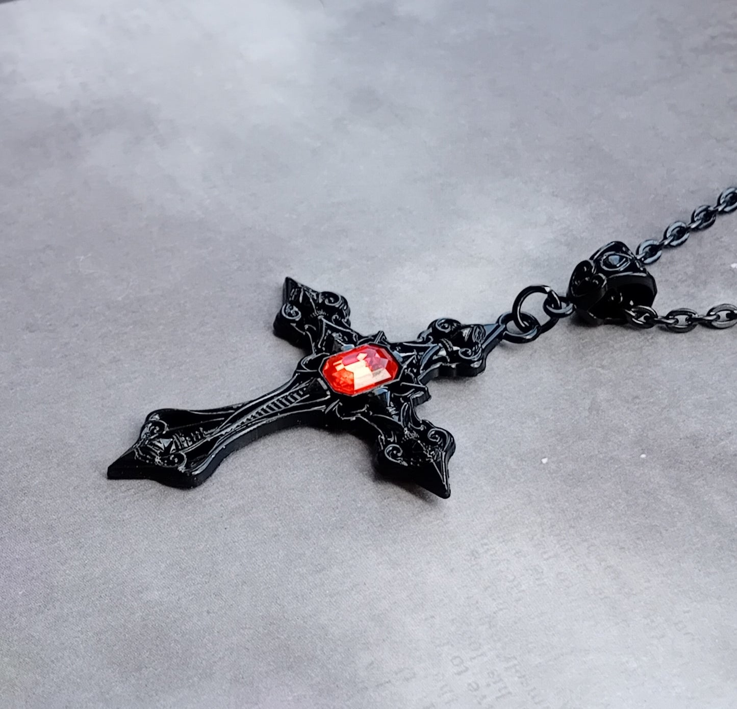 Black Patterned Cross with Red Stone