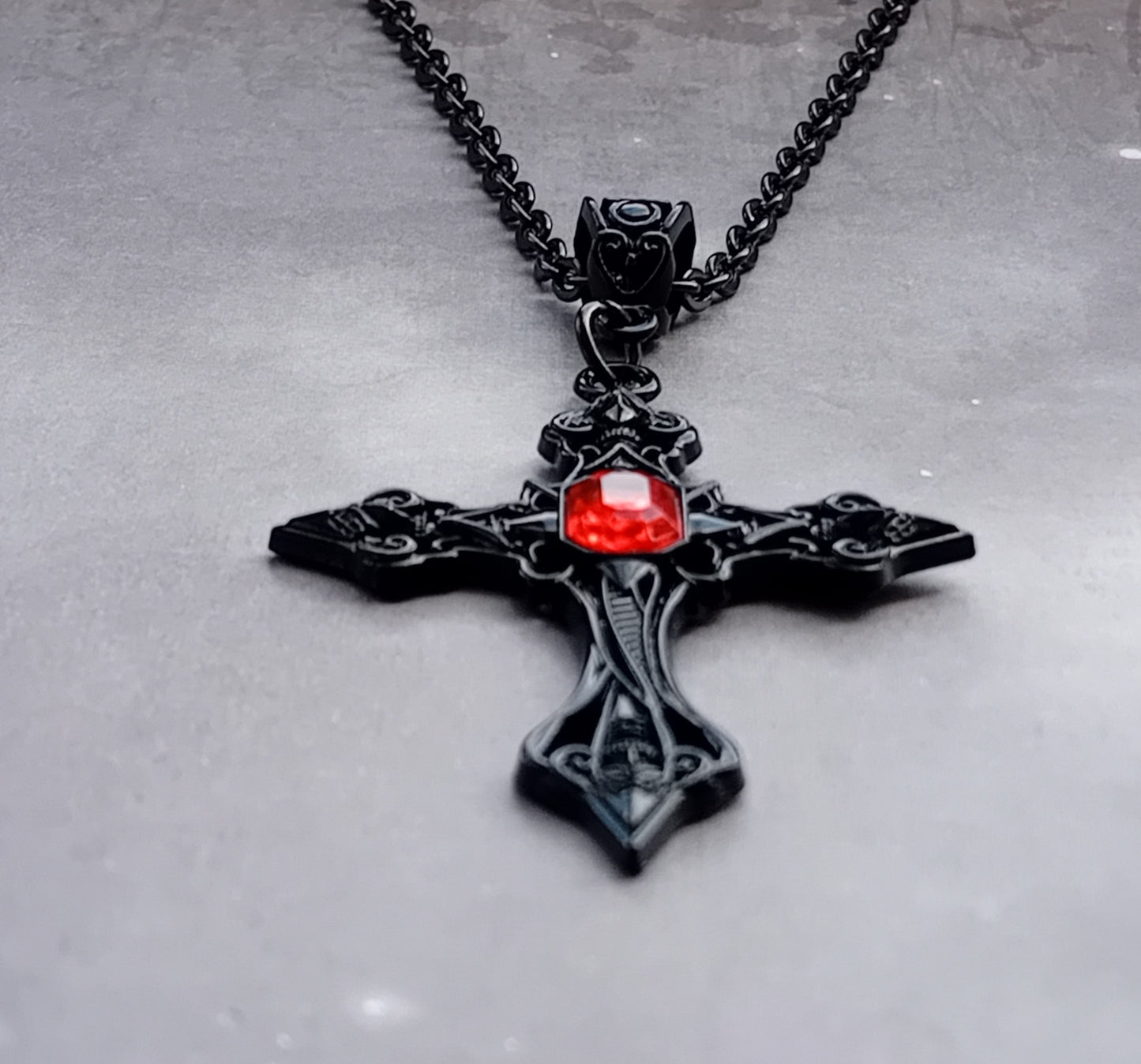 Black Patterned Cross with Red Stone